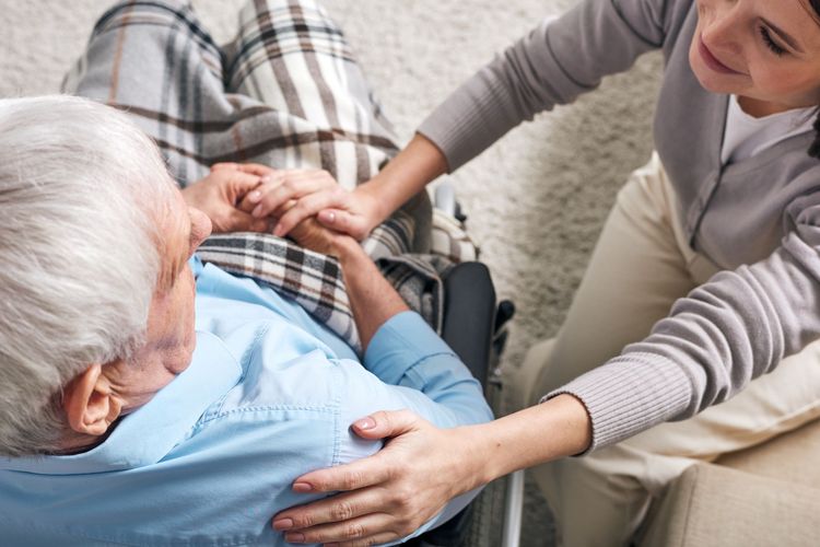 A supportive caregiver providing comfort to a senior resident, embodying The Springs' mission of compassionate, personalized care.